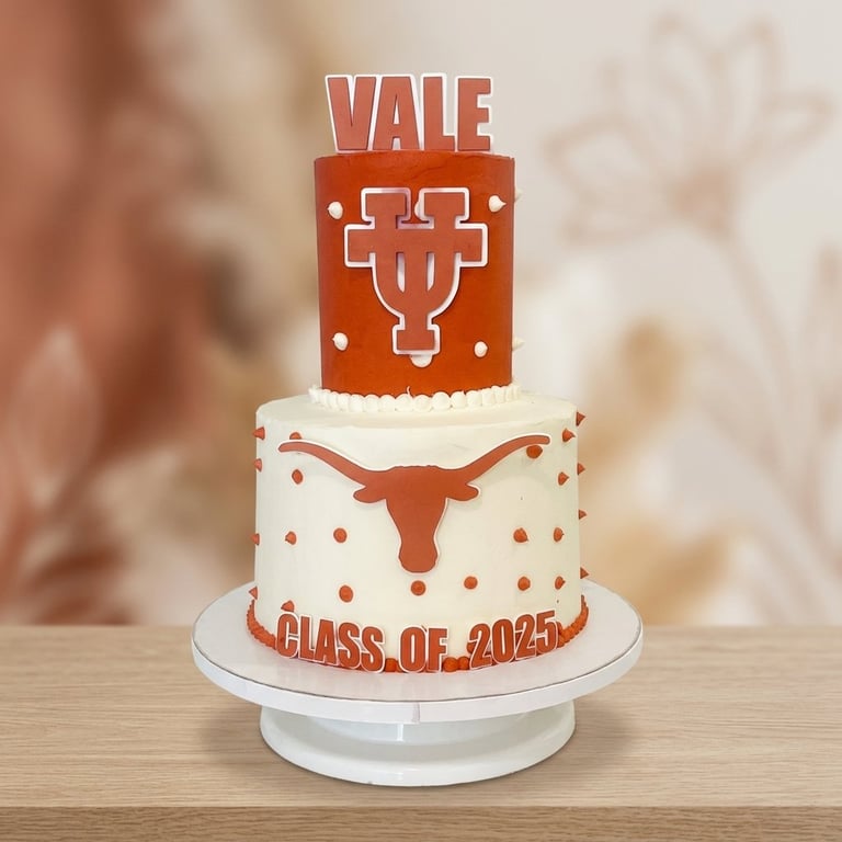 Two-tier graduation cake with 'VALE' topper, burnt orange and ivory design, and 'Class of 2025' decoration.