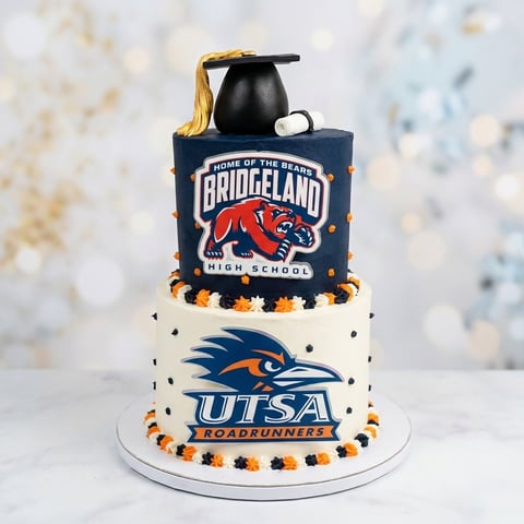 Two-tiered graduation cake with Bridgeland High School and UTSA Roadrunners logos, topped with black mortarboard cap and gold tassel